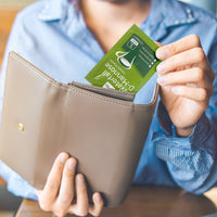 Waterfall D-Mannose sachets lifestyle image showing the credit card sized sachets fitting in to a purse or wallet. 
