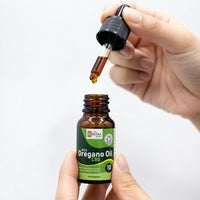 Lifestyle image showing how the Wild Oregano Oil C80 10ml pipette works with a droplet forming on the bottom of the pipette above the bottle neck.