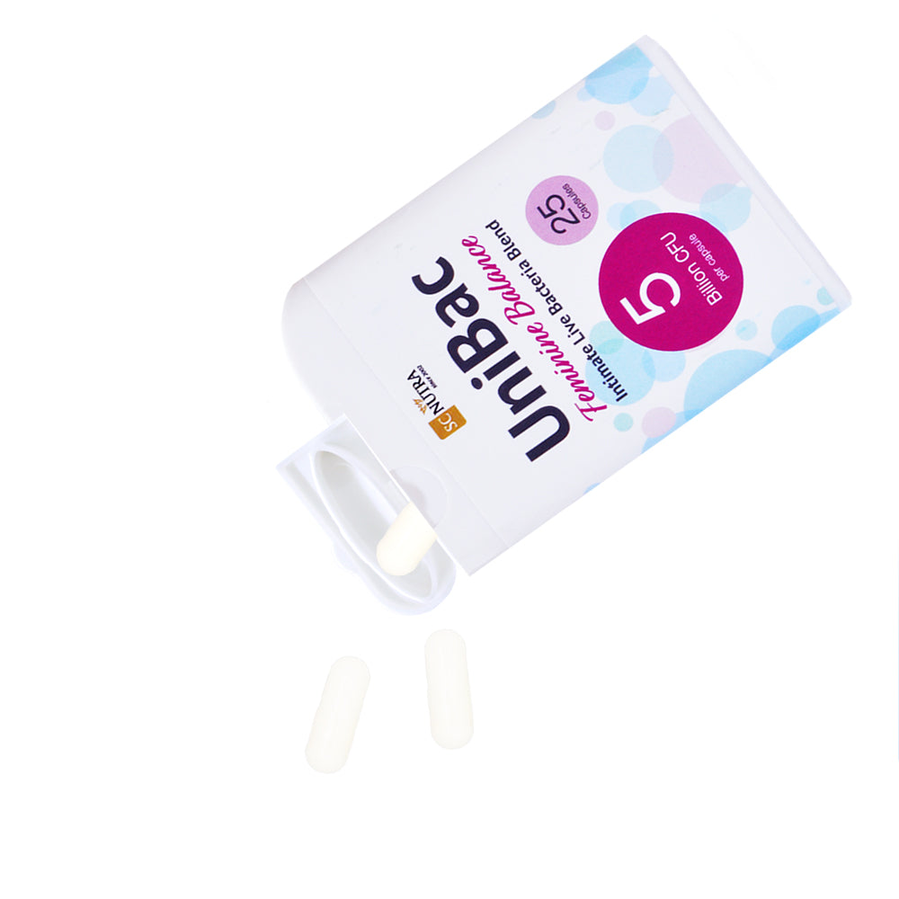 UniBac Feminine Balance live friendly bacteria capsules being tipped out of their dispenser. Lifestyle image showing dispenser use.